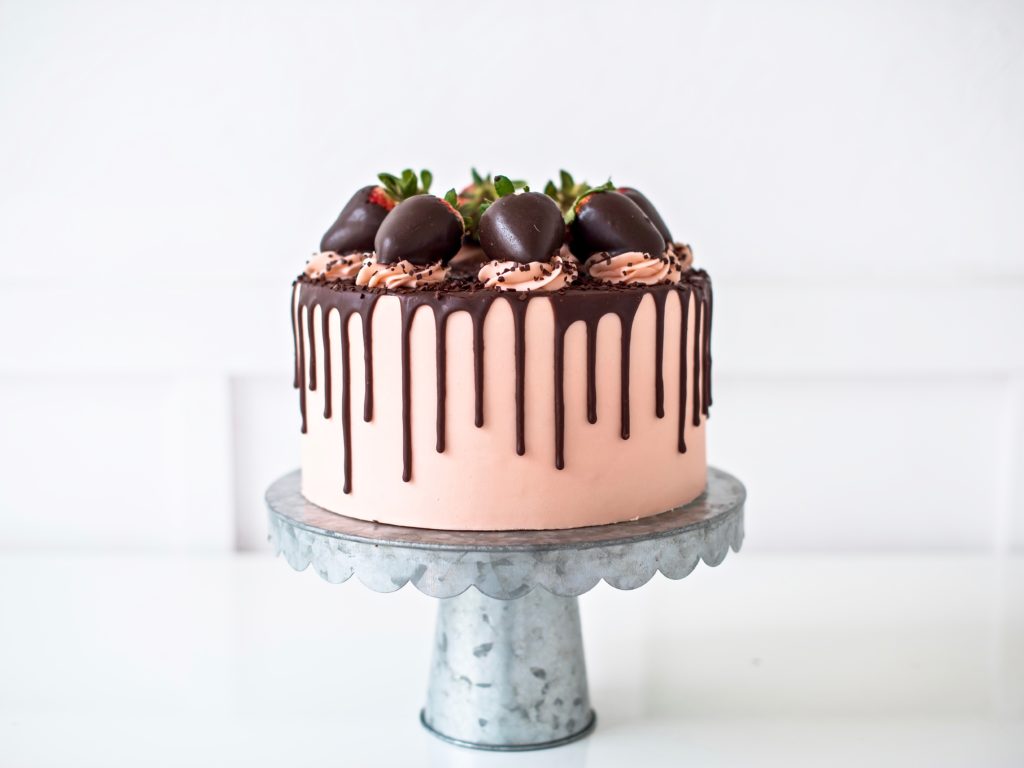 Rich dark chocolate cake layers with fresh strawberries, strawberry buttercream and chocolate ganache.
