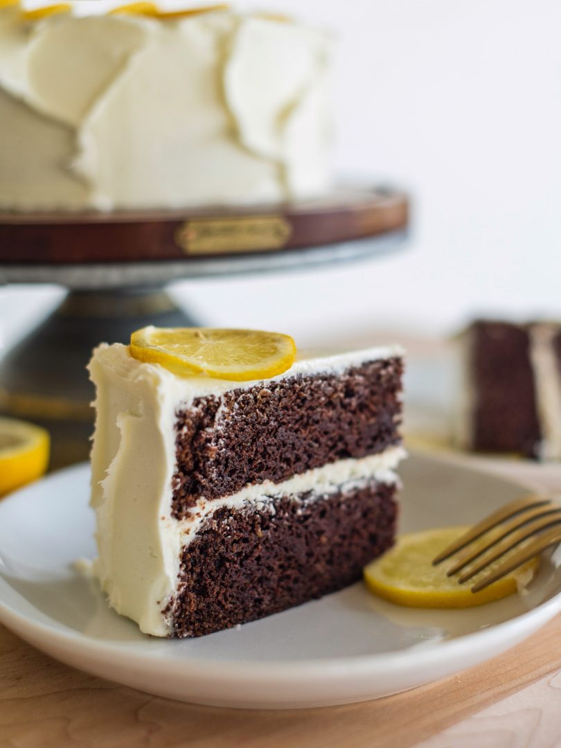 Cake by Courtney - Chocolate Lemon Zucchini Cake #chocolatecake #chocolatezucchinicake #lemoncreamcheesefrosting #chocolatelemonzucchinicake Cake slice on plate.