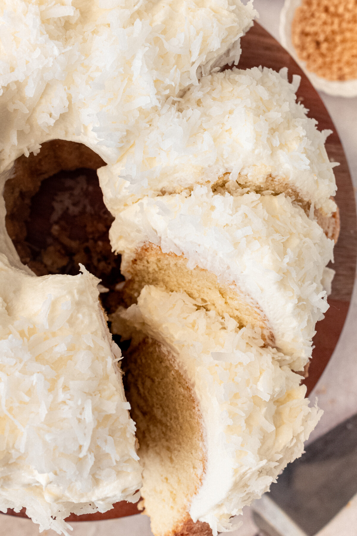Coconut bundt cake with slices cut into it. 