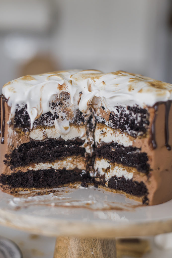 Ultimate S'mores Cake - Get ready for THE PERFECT summer cake! My dark chocolate cake layers are baked on a graham cracker crust, topped with chocolate ganache toasted marshmallow filling, chocolate buttercream and a toasted homemade marshmallow fluff. It doesn't get more ultimate than this! #cakebycourtney #ultimatesmorescake #chocolatecake #smores #smorescake #smorescakerecipe #smoresdessert #summerdessert #chocolate buttercream #summerrecipes #bestchocolatecakerecipe #bestchocolatecake #thebestchocolatebuttercream