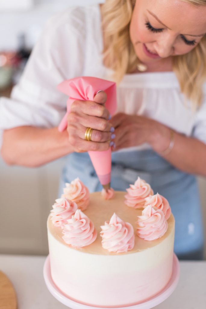 Coconut Lemon Raspberry Cake - coconut cake layers, lemon curd, raspberry cream filling, and coconut buttercream. #cakebycourtney #coconutcake #bestcoconutcake #lemoncurd #raspberrycream #raspberryfilling #coconutbuttercream #summercake #bestsummerdessertrecipes #summercakes #summerdessertrecipes 