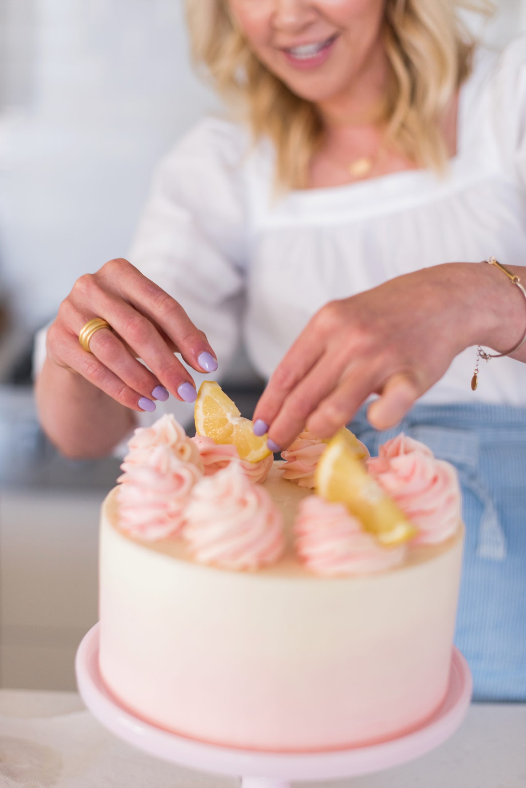 Adding lemon slices to a cake.