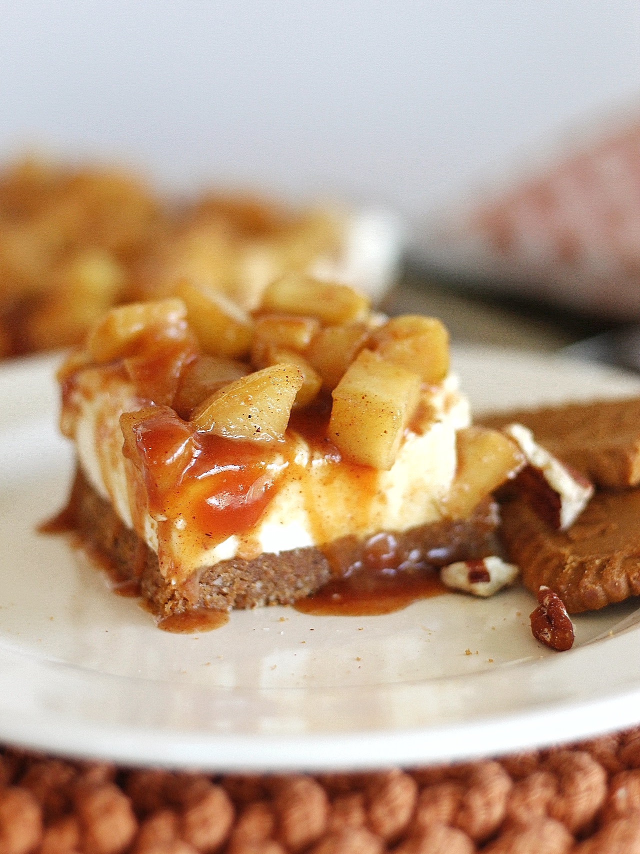 No-Bake Caramel Apple Cheesecake Bars with Biscoff Pecan Crust on a plate.